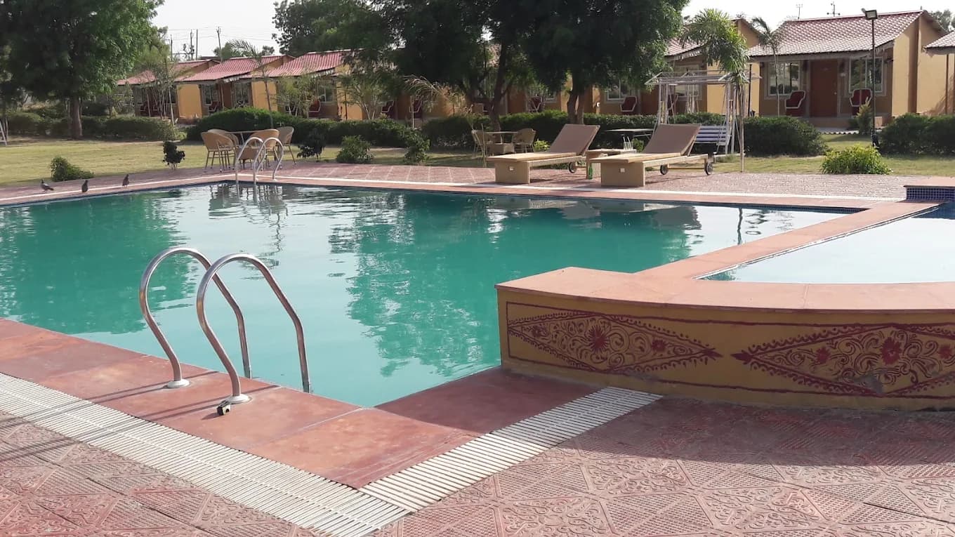 The swimming pool with cottages behind